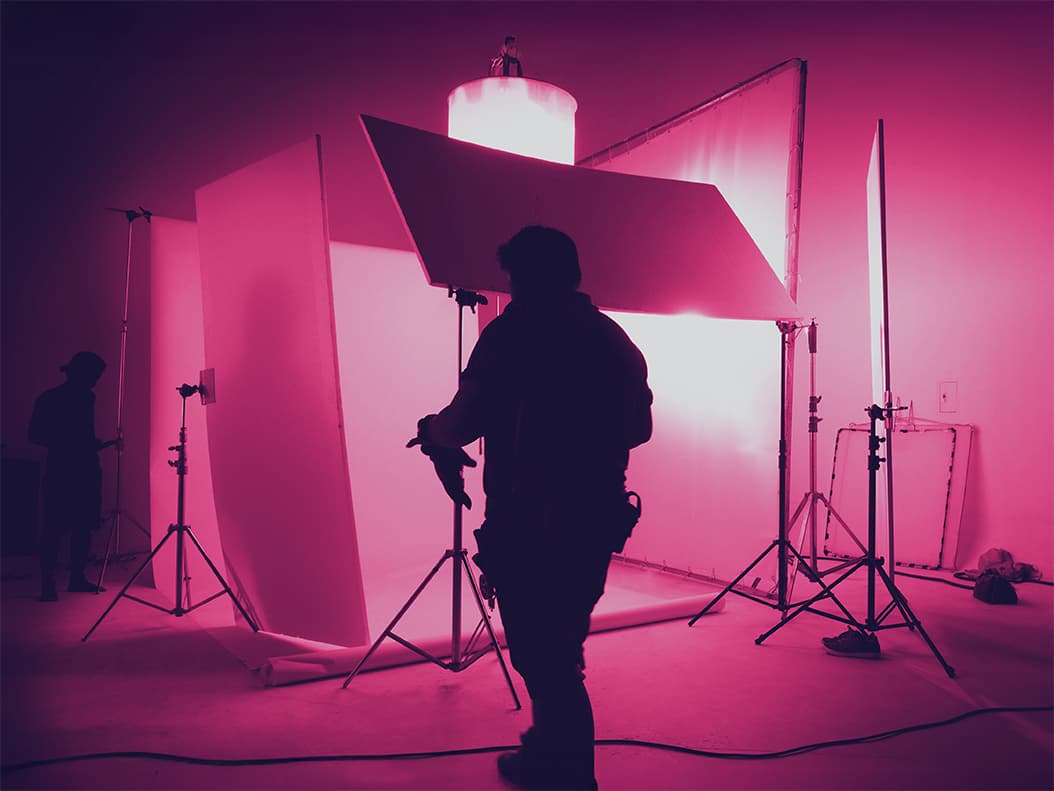 Content Strategy service image showing a shooting studio for photographer and creative art director with production crew team setting up lighting flash and LED headlight.