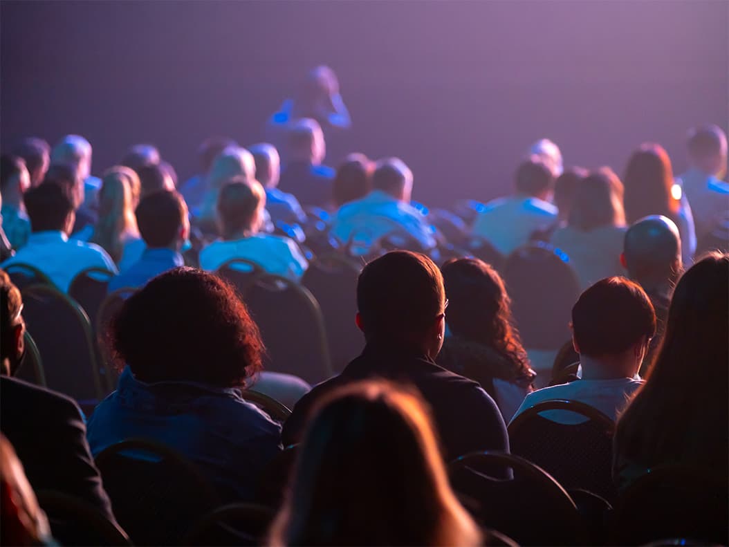 Digital Marketing & Communication service image showing a business conference attendees sit and listen.